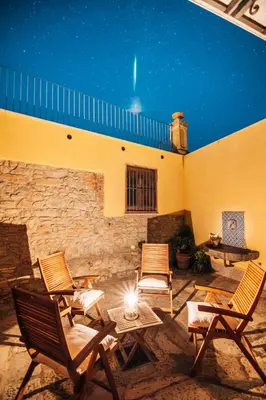 a group of chairs sitting on a patio at night at Casa al Bragone in Termini Imerese
