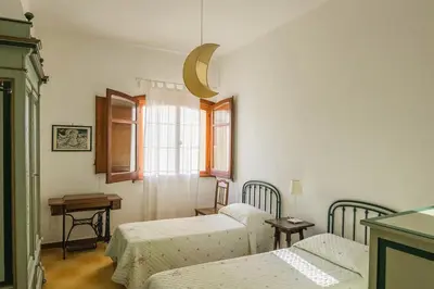 a room with three beds and a window at Casa al Bragone in Termini Imerese