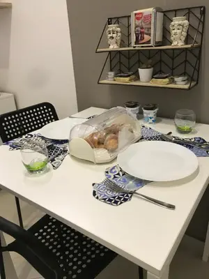 a table with two plates and a bag of food on it at centruMassimo b&b in Palermo