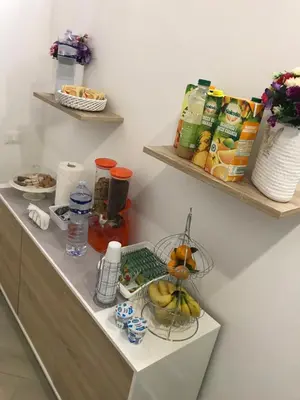 a kitchen with a counter with fruits and drinks at centruMassimo b&b in Palermo
