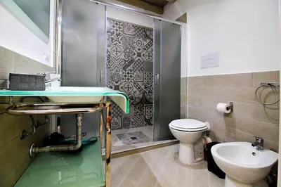 a bathroom with a shower and a toilet and a sink at centruMassimo b&b in Palermo