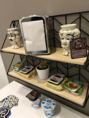 a shelf with a mirror and other items on it at centruMassimo b&b in Palermo