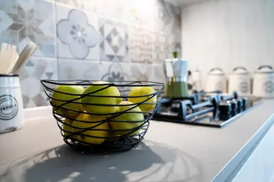 a bowl of lemons on a counter in a kitchen at Vasa Vasa Home in Palermo