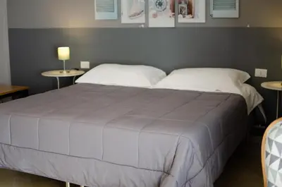 a bedroom with a large bed with two tables at B&B AL PASSIO in Palermo