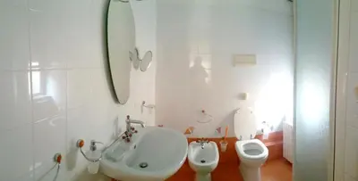 a bathroom with a toilet and a sink and a urinal at Benvenuti al Massimo in Palermo