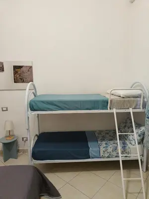 a bedroom with a bed and a tv on the wall at B&B IL POETA in Palermo
