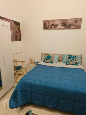 a bedroom with a bed and a chandelier at B&B IL POETA in Palermo
