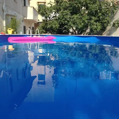 a swimming pool with a pink object in the water at Stardust Home in Palermo