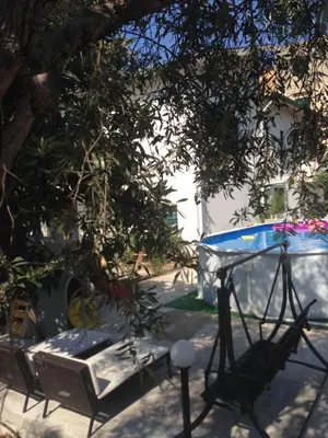 a table and chairs sitting under a tree at Stardust Home in Palermo