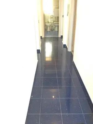 a hallway with a black tile floor in a bathroom at Stardust Home in Palermo