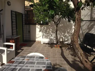 a room with two trees in the middle of a building at Stardust Home in Palermo