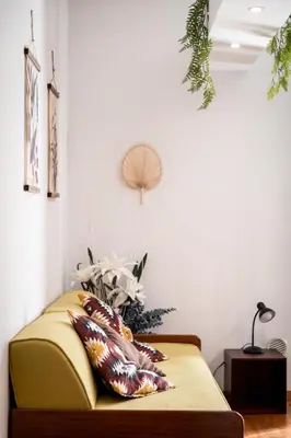 a room with a bed with a pillow and a fan at Tetide Home in Palermo