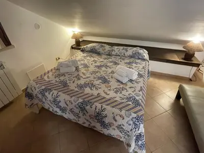 a bedroom with a bed with two pillows on it at MARE AZZURRO in Campofelice di Roccella
