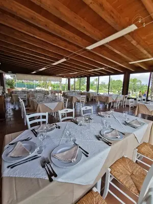 a dining room with white tables and white chairs at Azienda Agrituristica Baglio Carta in Balestrate