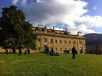 people standing in the grass in front of a building at Rua House in Corleone