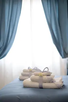 a pile of towels sitting on top of a bed at Scirocco House in Palermo