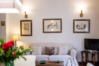 a living room with a couch and pictures on the wall at Scirocco House in Palermo