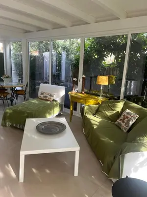a living room with a green couch and a table at Domus Orestea Luxury Suites in Palermo