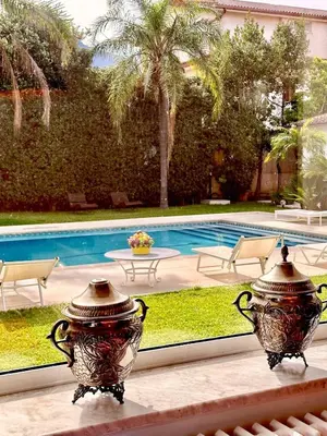 two vases sitting on a ledge next to a pool at Domus Orestea Luxury Suites in Palermo