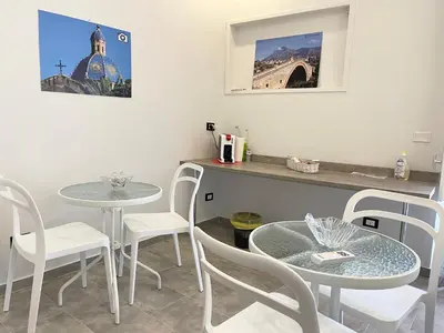 a dining room with two tables and white chairs at B&B Antichi Cortili in Termini Imerese