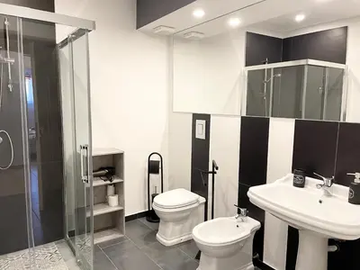 a bathroom with a toilet and a sink and a shower at B&B Antichi Cortili in Termini Imerese
