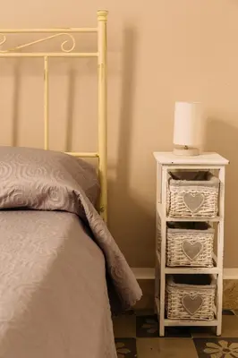 a bedroom with a bed and a night stand with a lamp at Il Tarì Apartment in Palermo