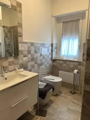 a bathroom with a toilet and a sink at Suite Vera in Palermo