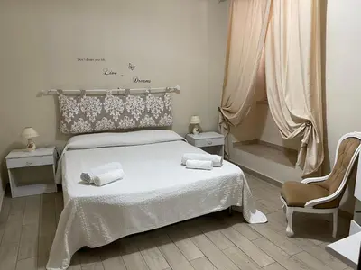 a bedroom with a bed with two towels on it at Hola Cathedral House in Palermo