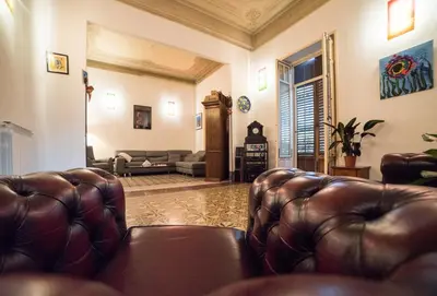 a dining room with a table and chairs at Medusa in Palermo