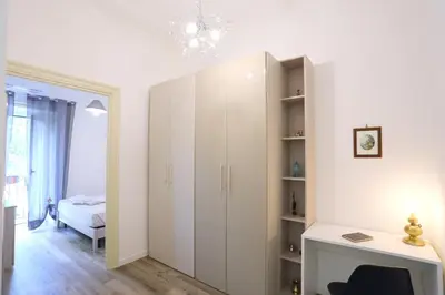 a room with a white cabinet and a desk at Sol&Luna 1909 in Palermo