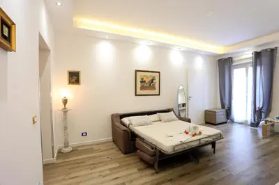 a living room with a bed and a couch at Sol&Luna 1909 in Palermo