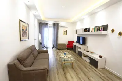 a living room with a couch and a tv at Sol&Luna 1909 in Palermo
