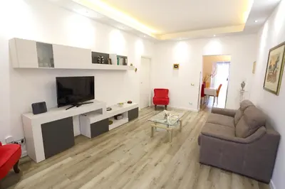 a living room with a couch and a flat screen tv at Sol&Luna 1909 in Palermo