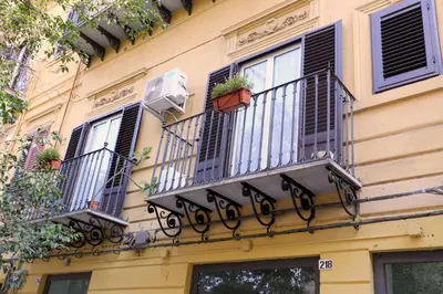 a building with two balconies with plants on it at Sol&Luna 1909 in Palermo