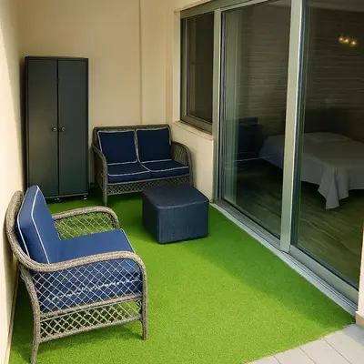 two chairs and a ottoman sitting on a porch at Mondello's Pearl in Mondello