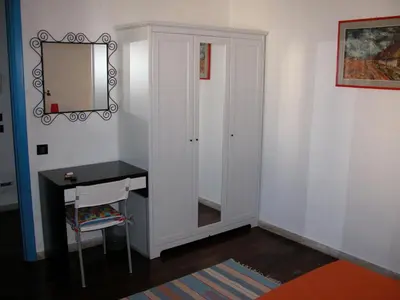 a room with a vanity and a mirror and a desk at La Caletta in Santa Flavia
