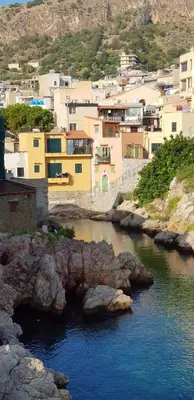 a view of a river in a city with buildings at La Caletta in Santa Flavia