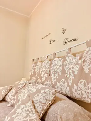 a bedroom with a bed with gray and white pillows at Hello Cathedral House in Palermo