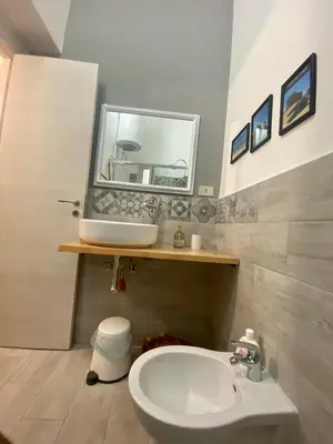 a bathroom with a sink and a mirror at Apartament Home Lory in Palermo