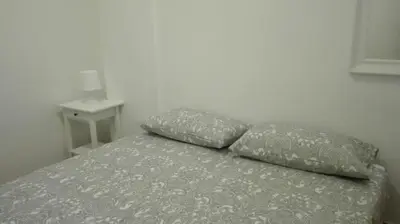a bed with two pillows on top of it at Casavacanze corallo in Isola delle Femmine