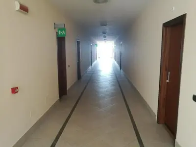a hallway with a long hallway with a sign on it at Casavacanze corallo in Isola delle Femmine