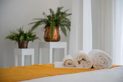 a pile of towels sitting on top of a bed at COCCIU D’AMURI in Castellammare del Golfo