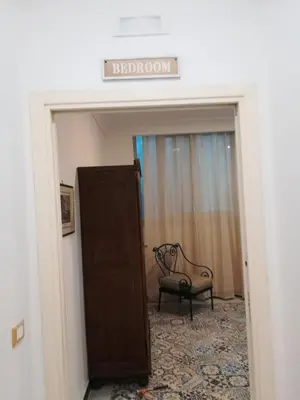 a door to a room with a chair and a sign at Hostel Tribunale Room Basement in Palermo