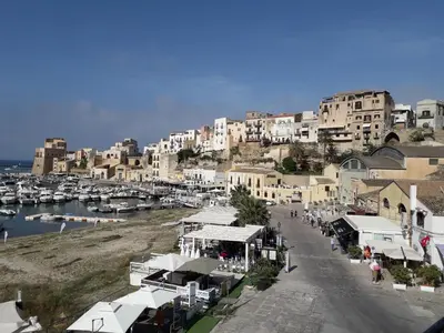 a town with a marina with buildings and boats at Liberty house in Castellammare del Golfo