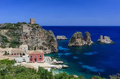 a house on a rocky island in the water at Liberty house in Castellammare del Golfo