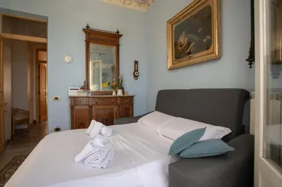 a bedroom with a bed with towels on it at Liberty house in Castellammare del Golfo