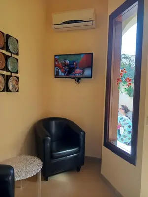 a black leather chair in a room with a window at Amaryllis Hotel in San Vito lo Capo