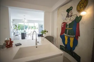 a kitchen with a sink and a painting on the wall at Villa Corallo in Cinisi