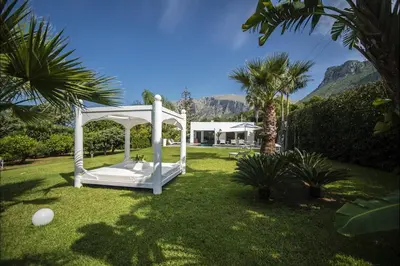 a white gazebo in the yard of a house at Villa Corallo in Cinisi