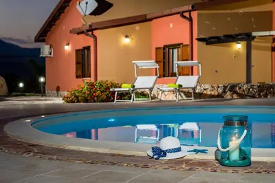 a swimming pool with a mason jar and a beach ball in it at Villa Thyrrenia in Castellammare del Golfo